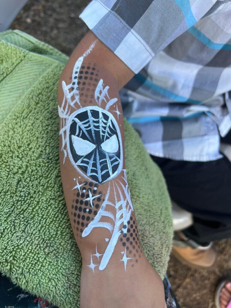 Picture of spider mans face on Childs arm