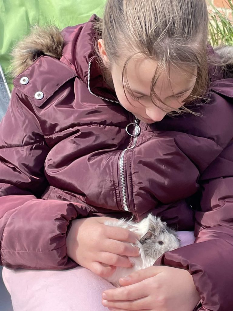 Picture of a girl holding a guinea pig